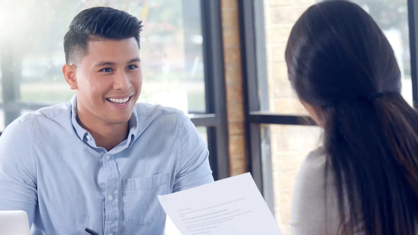 a man smiling at a woman