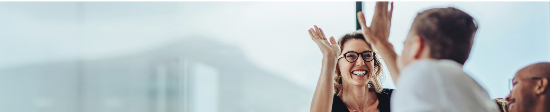 Two people smiling and high fiving.