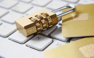 A pad lock on top of a computer keyboard. 